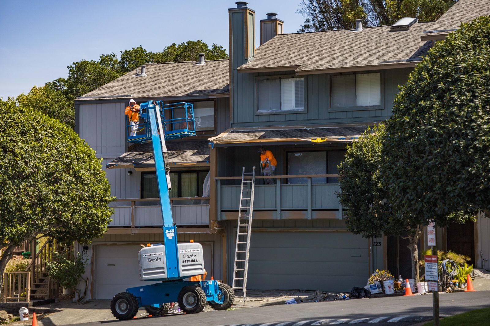 Crew performing exterior repairs on a residential property